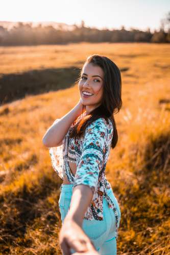 mudgeeraba qld girl in blue and white floral dress standing on brown grass field during daytime smiling